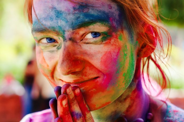 holi festival woman with colors on face rainbow
