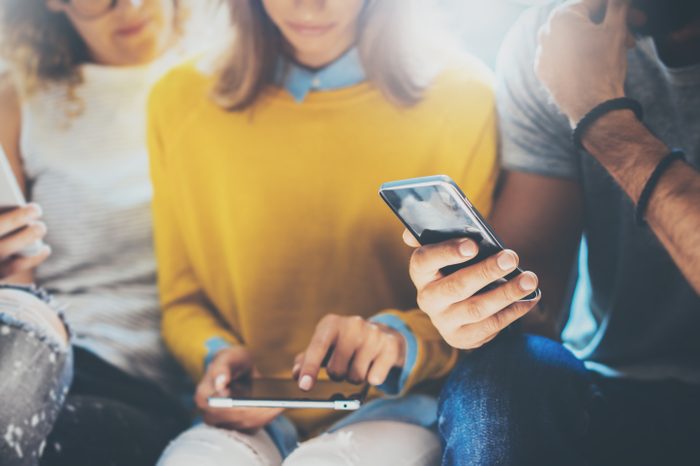 group of people taking quiz on smart phones