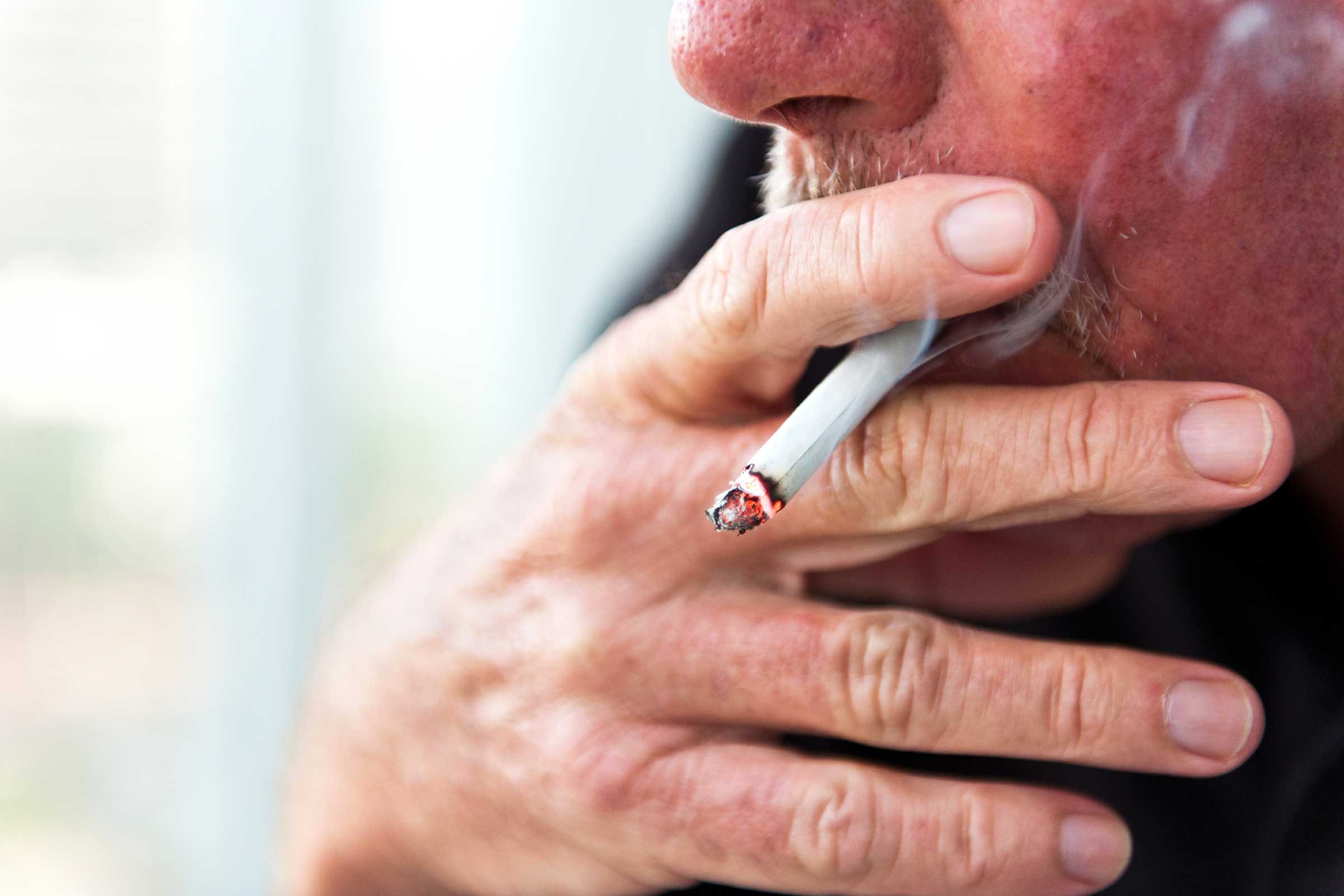 Male smoking a cigarette.