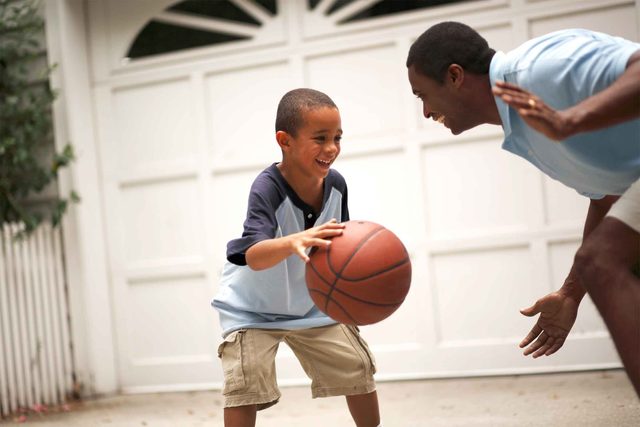 father and son playing basketball