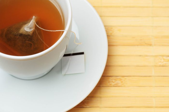 tea bag steeping in a white tea cup