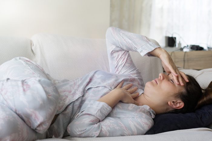 woman lying down with headache