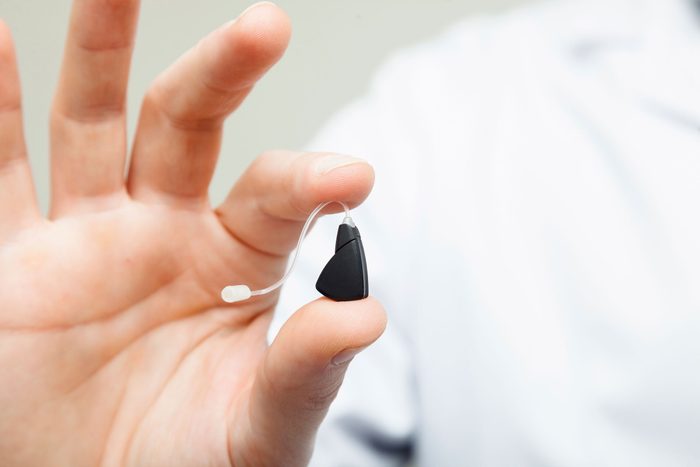 person holding hearing aid