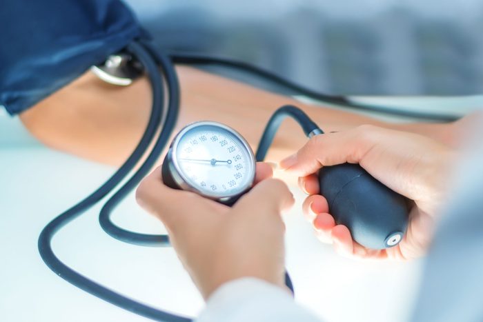 doctor measuring blood pressure on patient's arm