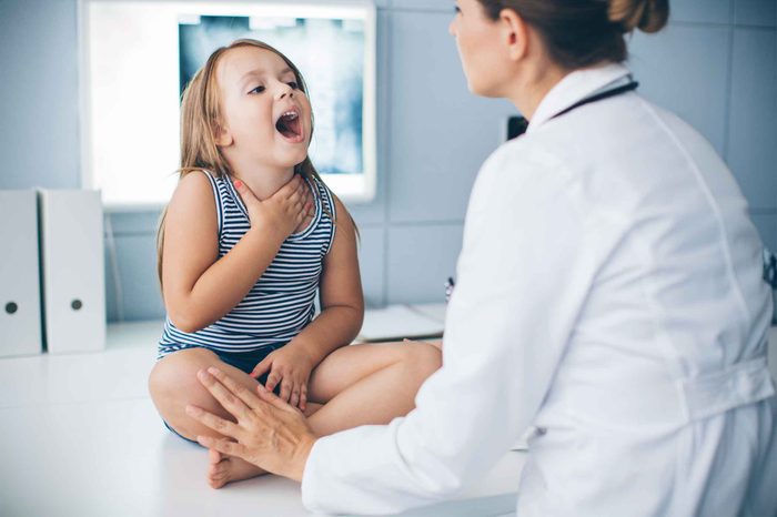Little girl in the doctor's office with swollen lymph nodes.