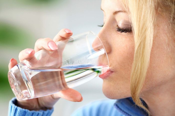 Woman drinking water.