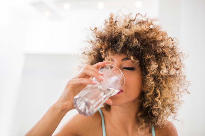 Woman drinking water.