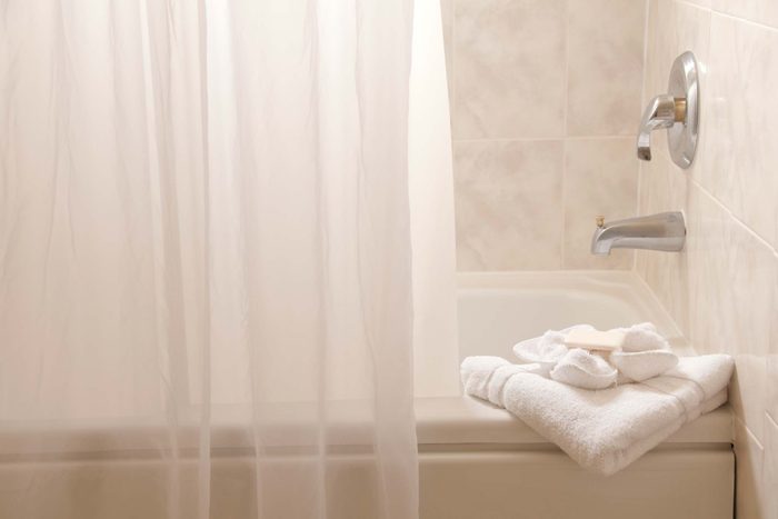 Bathtub with shower curtain.