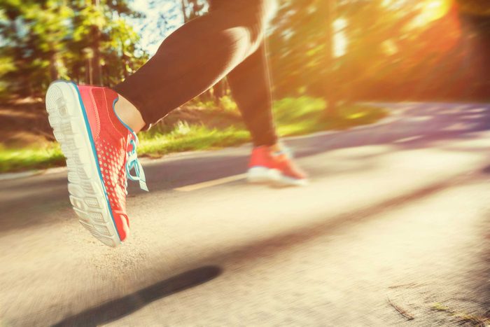 Woman jogger running on a trail.