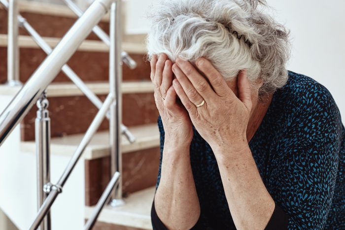 mature woman with her head in her hands