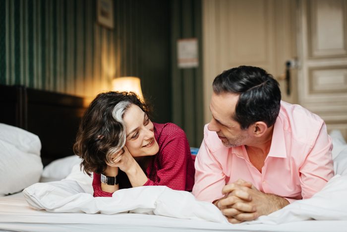 happy couple lying in bed