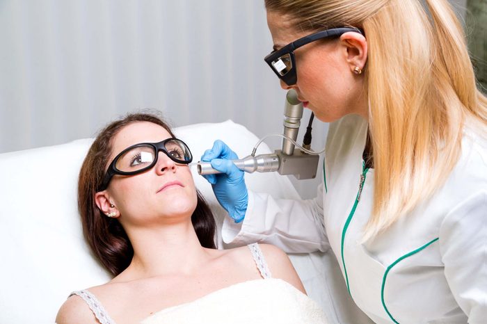 female patient in eye protective gear getting VBeam treatment in healthcare setting