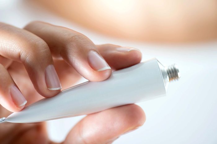 hand holding tube of cream