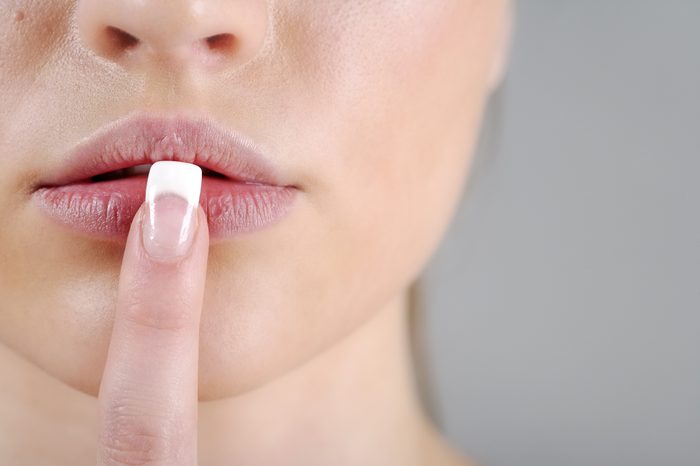 woman finger on lips dry