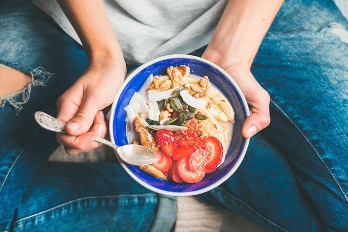woman holding healthy salad in a bowl