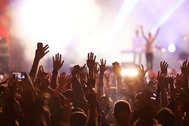 concert with fans waving hands