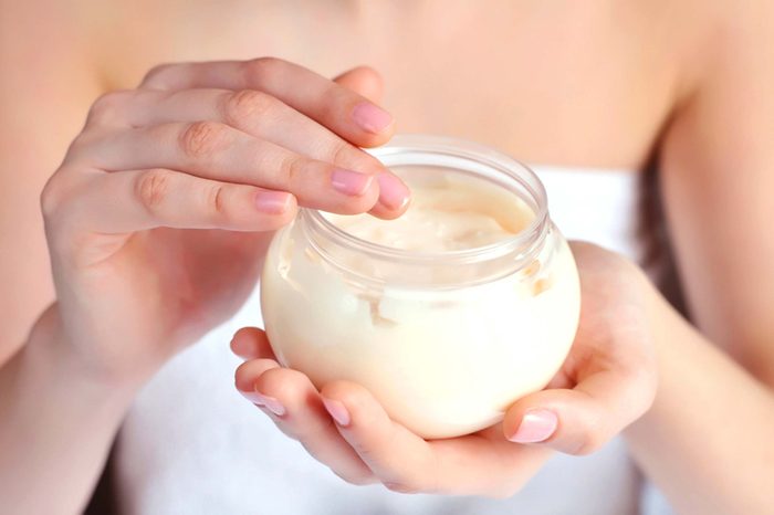 woman holding moisturizer