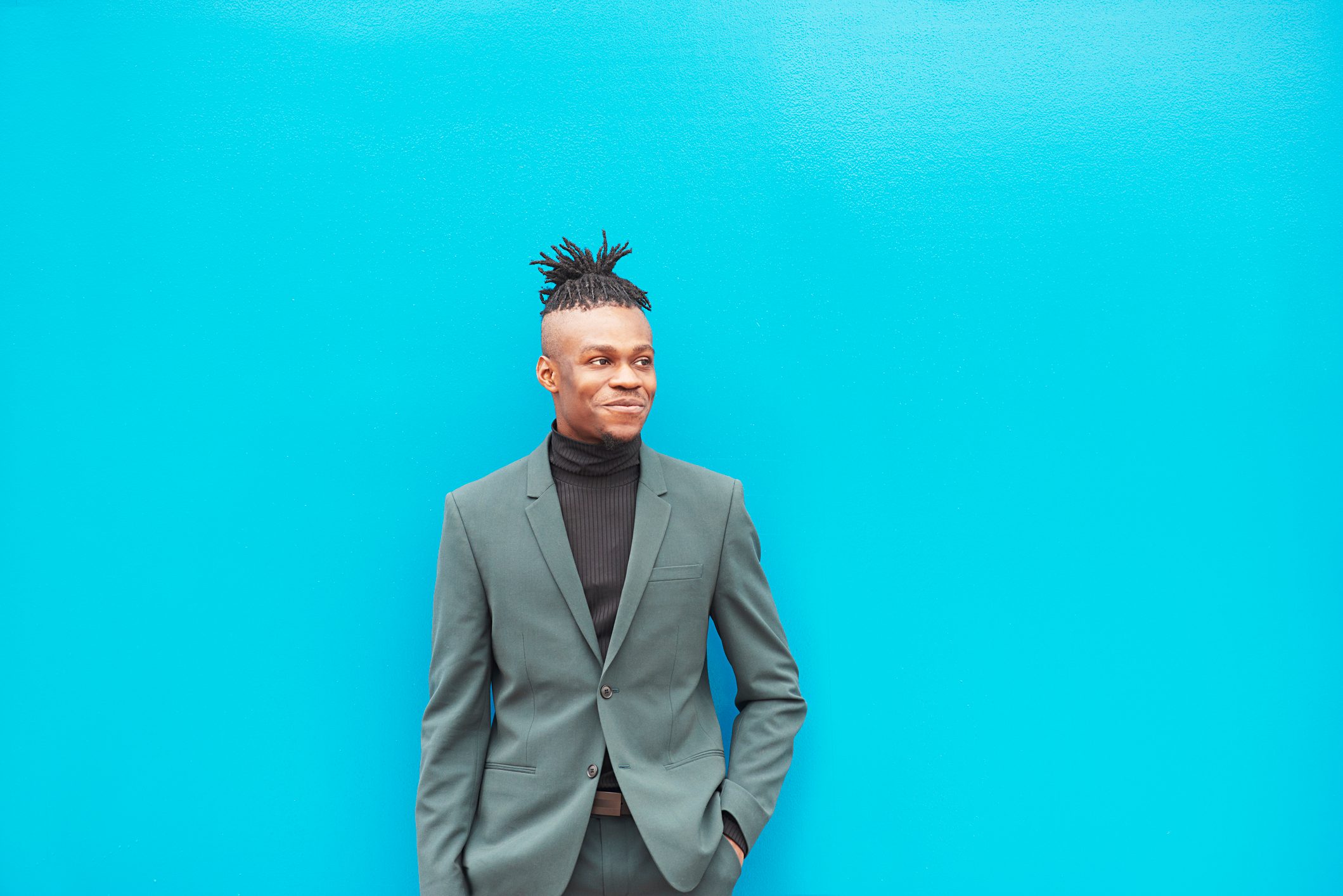 young businessman on bright blue background
