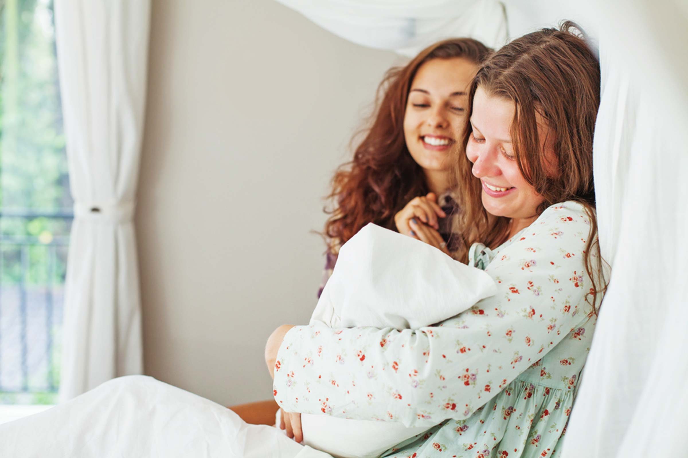 women holding baby