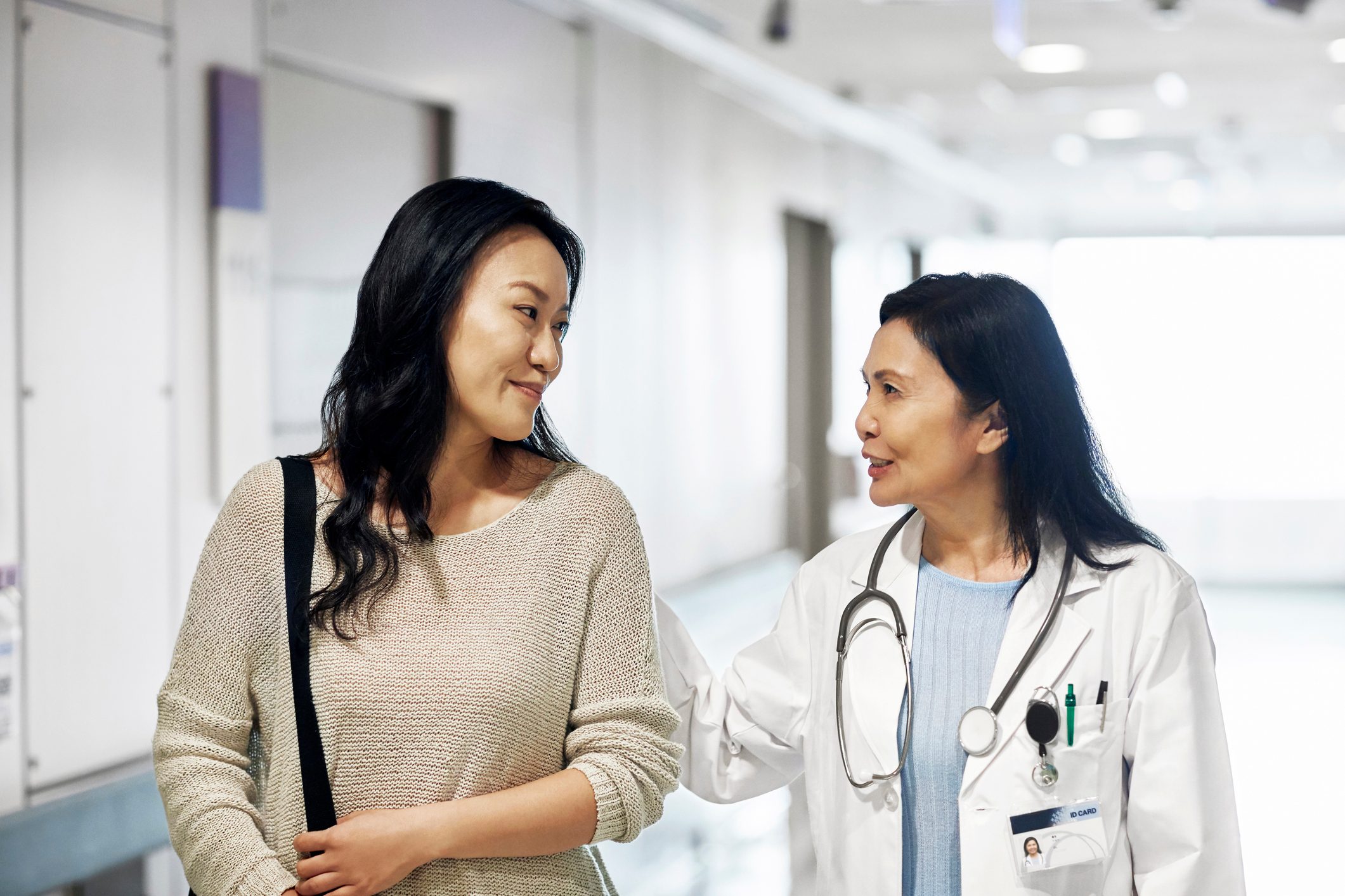 woman talking with doctor while walking