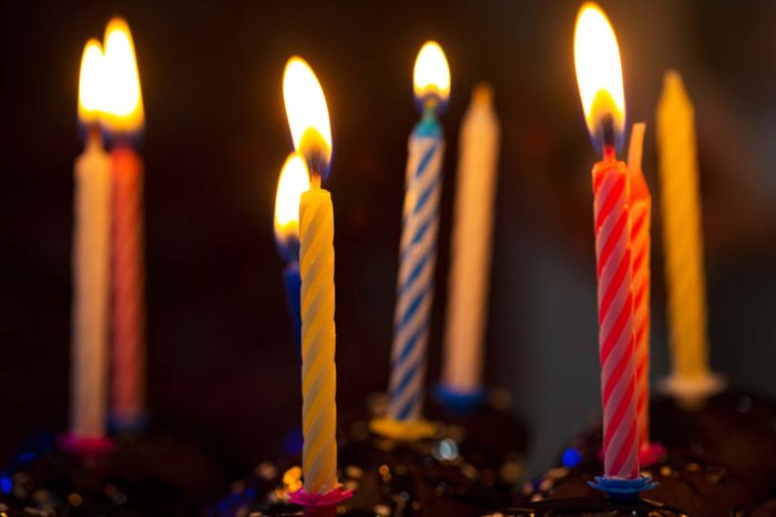 lit birthday candles in cupcakes