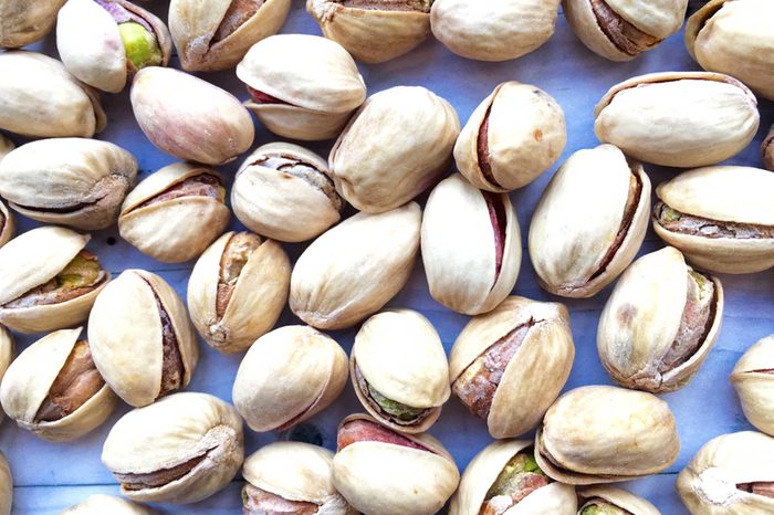 pistachios in the shell on a blue background