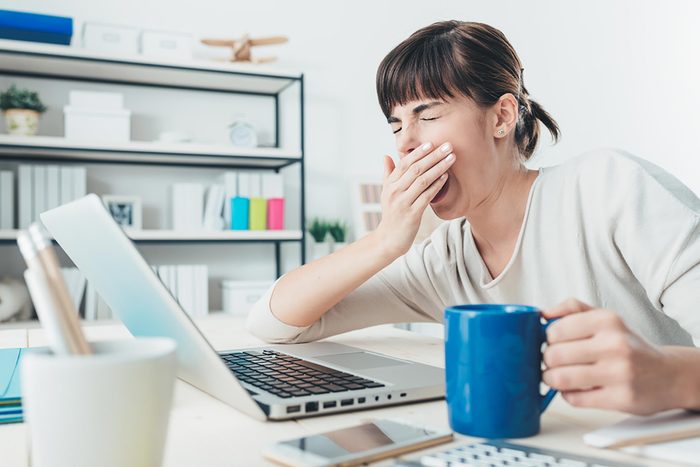yawning women at computer