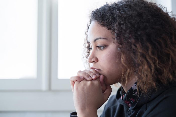 depressed woman with chin in her hands