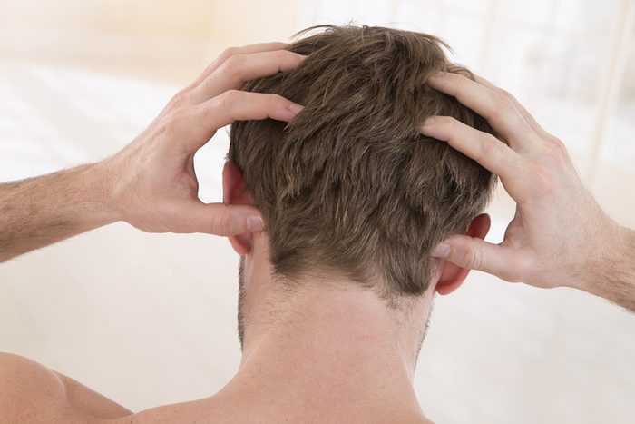 man scratching head