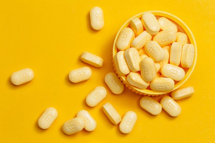vitamins overflowing a small bowl on a table