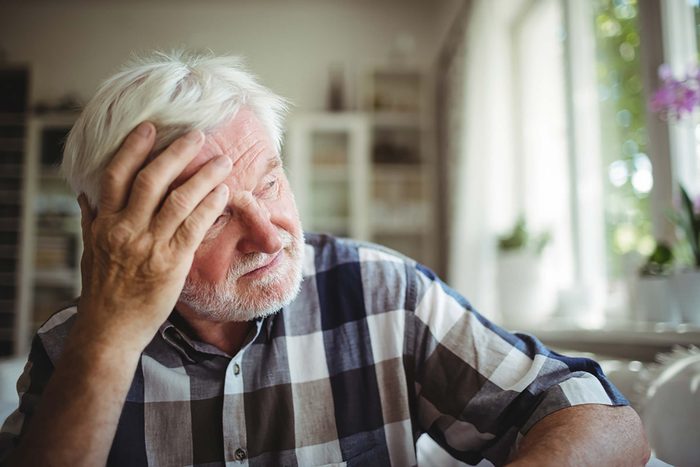 senior man holding his head