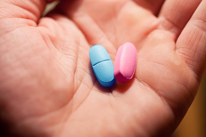 Closeup of supplements on a person's palm.