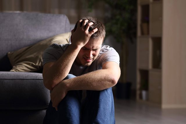 angry man holding his head
