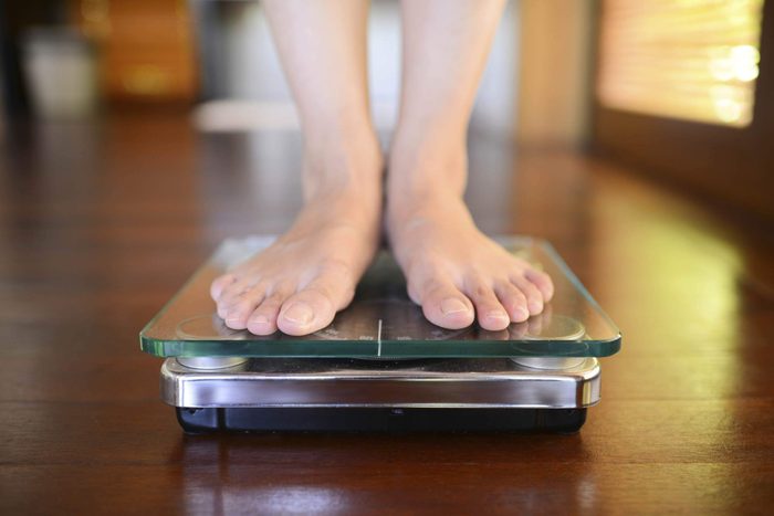 Closeup of someone's feet on a scale.
