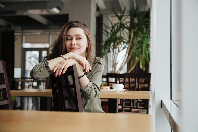 happy woman sitting in a chair