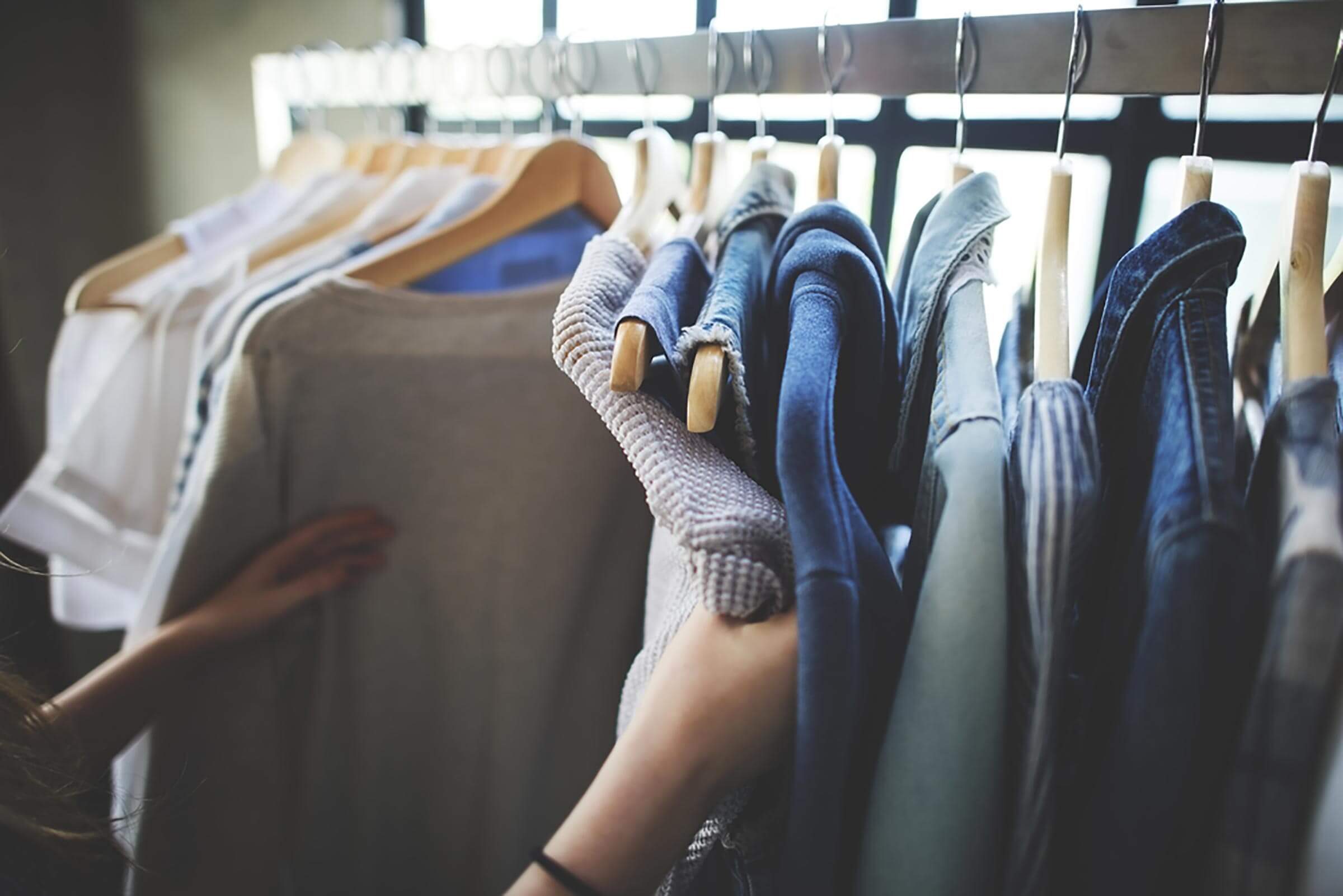 hands on clothes on rack