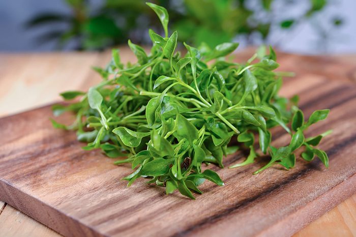 Watercress on wooden chopping board