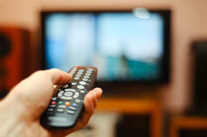 hand pointing remote at tv