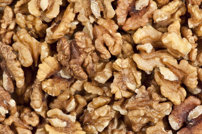 Heap of unshelled walnuts, seen from directly above and in full frame