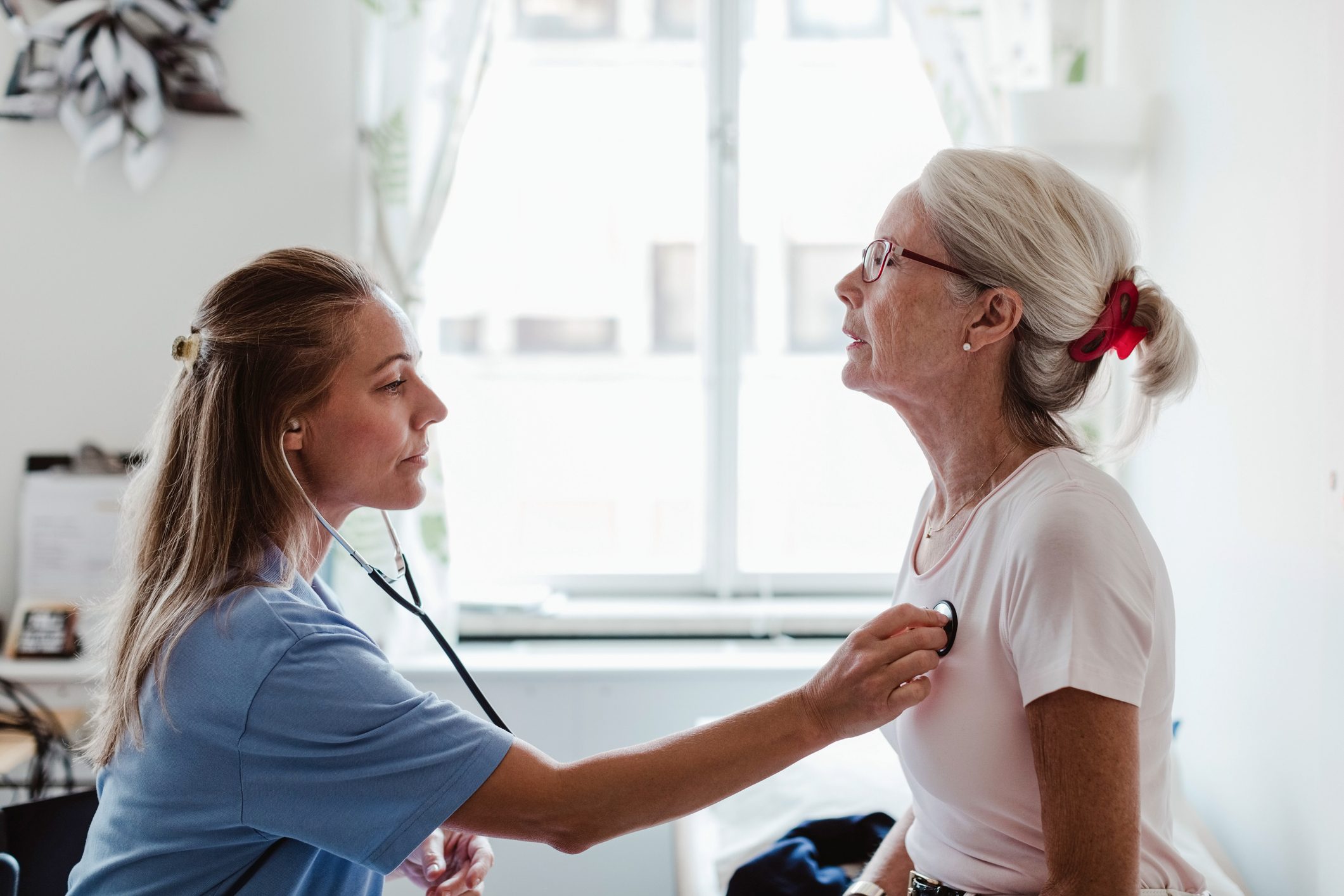 doctor checking patient's heartbeat