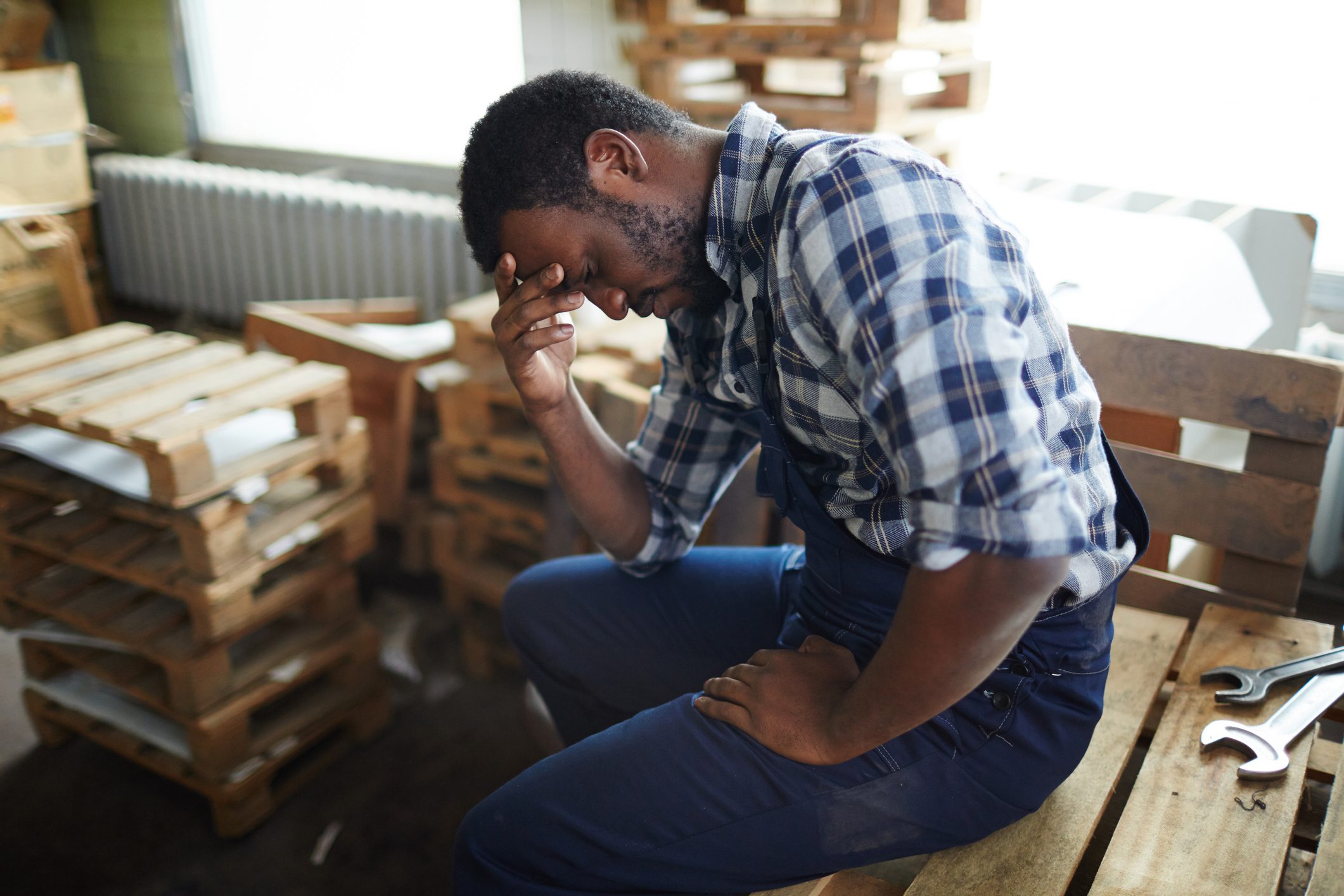 man suffering from a headache at work