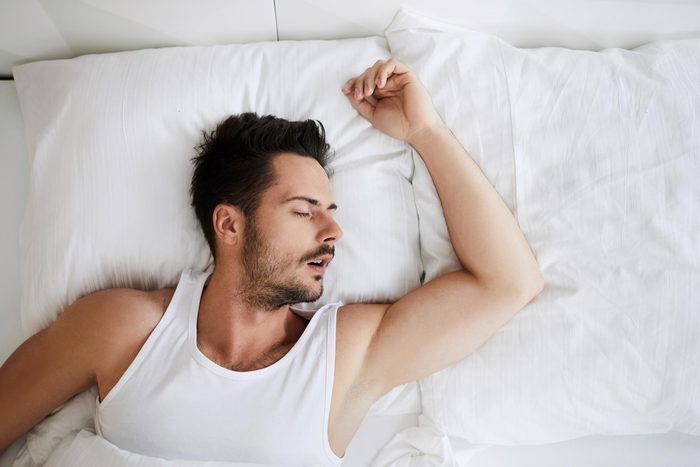 man sleeping on his back, mouth open