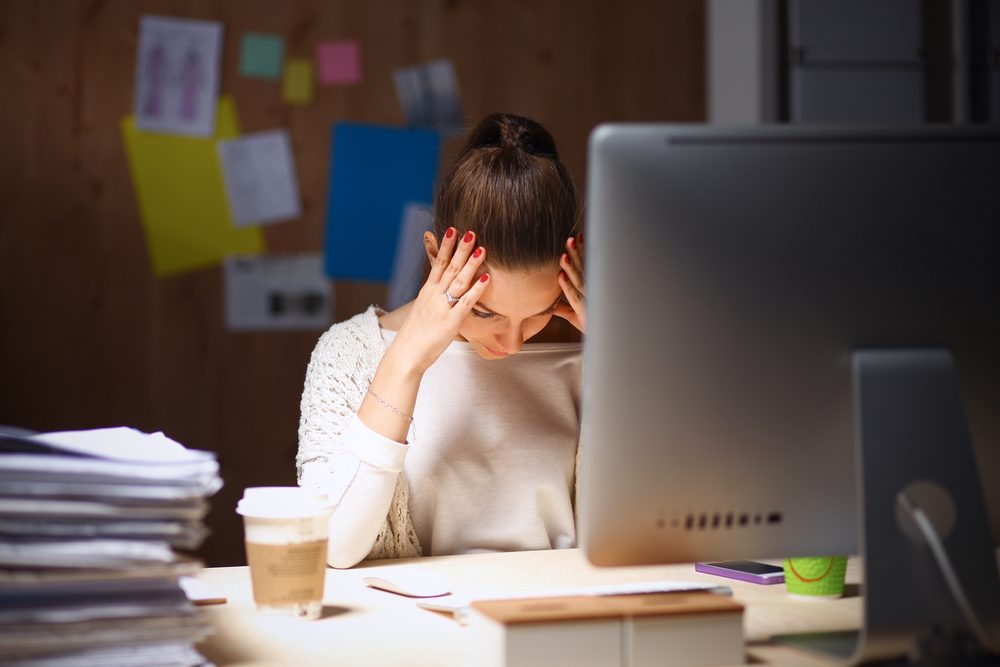 Young and beautiful businesswoman tired from work in the office