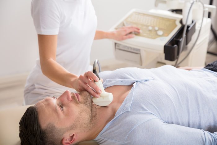man getting a thyroid ultrasound