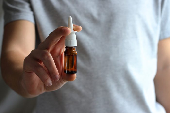 Nasal spray in male hands.