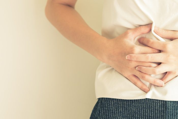 woman holding her stomach