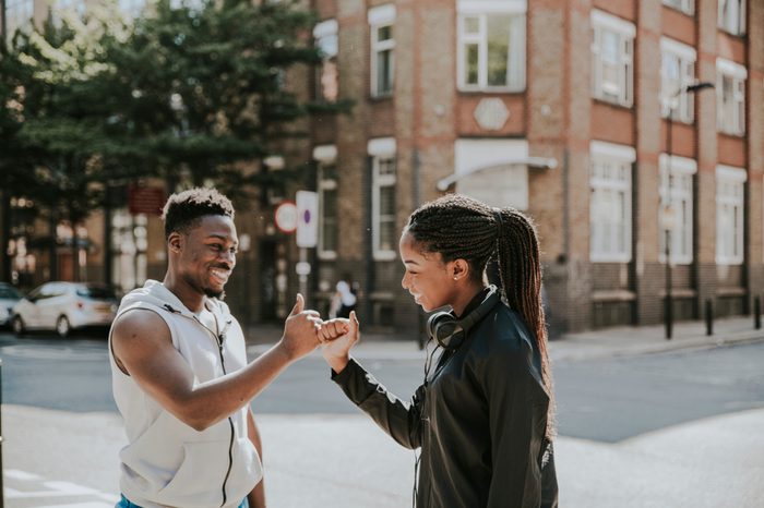 Friends greeting with a signature handshake