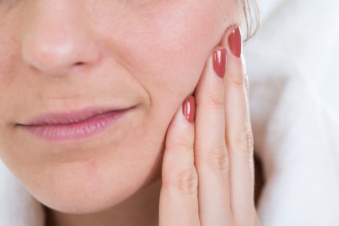 Close-up Of A Woman With Toothache Touching Face