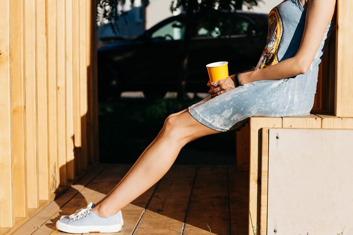 Woman wearing a dress with sneakers