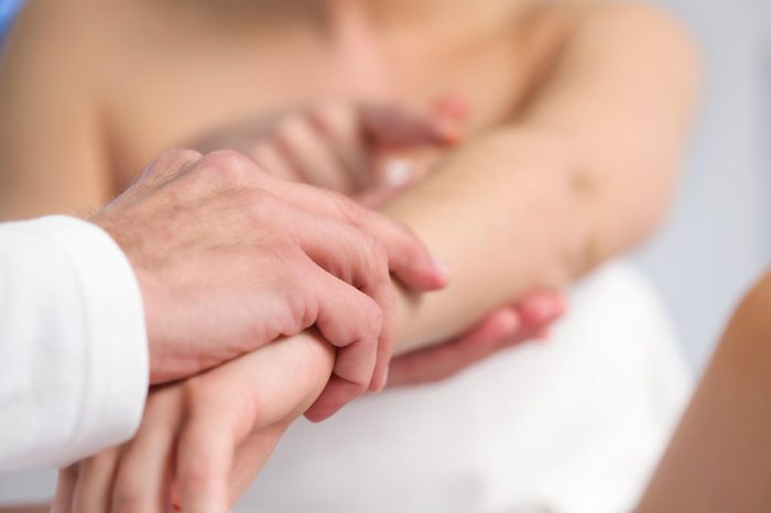 doctor examining a patient's arm